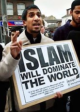 Picture: Muslim holding a sign: Islam Will Dominate The World