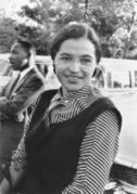 Rosa Parks in 1955, with Martin Luther King, Jr. in the background.