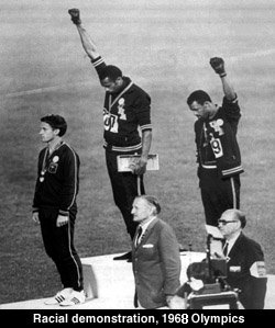 Tommie Smith(ctr) and John Carlos showing the Black Power salute in the 1968 Summer Olympics