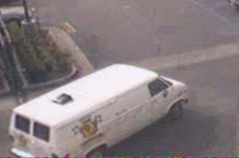Suspects getaway vehicle - a white cargo van, unknown license, has unknown logo on its right and rear sides.