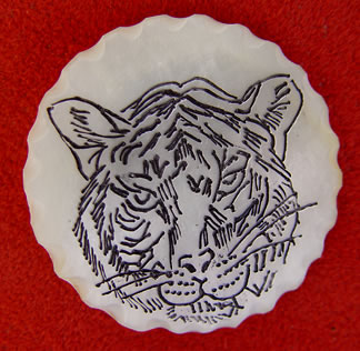 scrimshaw on mother-of-pearl, tiger button by Diane Schefferly