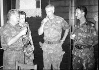 Bosnian Serb army Commander General Ratko Mladic, left, drinks a toast with Dutch UN Commander Tom Karremans, second right, during Srebrenica Massacre July 12, 1995.
