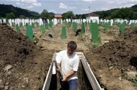 A Bosnian worker digs a grave during preparations for burial of 500 identified victims of the Srebrenica massacre at the Memorial Center Potocari, near Srebrenica, 120 km (75 miles) north of Sarajevo on Wednesday, July 5, 2006. The burial ceremony for 500 recently identified victims of the Srebrenica massacre exhumed from numerous mass graves is to be held on Tuesday, July 11. (AP Photo/Amel Emric) 