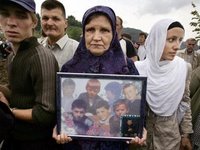 Srebrenica Mother Holds Photo of her Children who Perished During Srebrenica Massacre (Never Forget 7/11/1995 - Srebrenica Genocide)