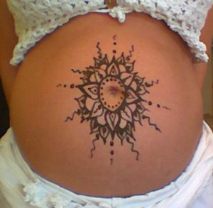tribal sun tattoo in henna for pregnancy