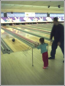 and watches it roll down the lane.