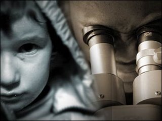 Image of a child next to a man looking into a microscope