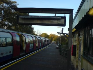 A Northern Line train waits to depart from Mill Hill East station