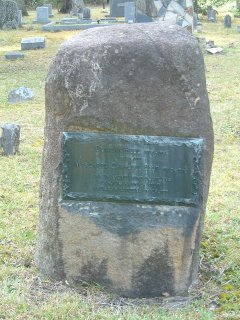 Shot of large rock grave marker.