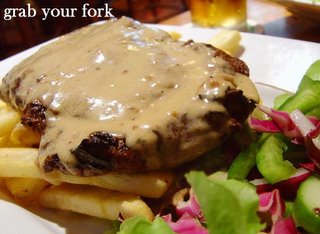 fillet steak with peppercorn sauce, chips and salad