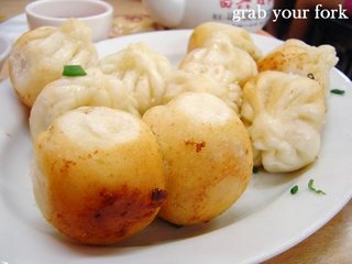 Pan-fried pork buns with crispy bottoms showing
