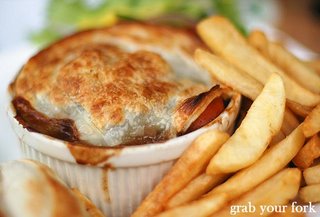 beef and Guinness pie with chips closeup