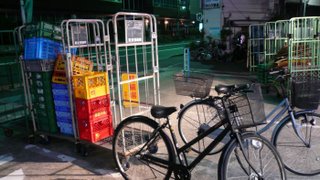 bikes and crates in the early morning infront of the local 99yen shop