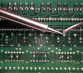 A circuit board being soldered - lead-free will be more expensive and less good for the environment