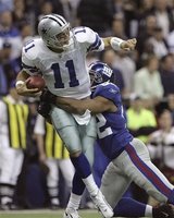 Dallas Cowboys quarterback Drew Bledsoe (11) is sacked for a loss of six yards by New York Giants defensive end Michael Strahan (92) in the 2nd quarter of their football game in Irving, Texas, Monday, Oct. 23, 2006. (AP Photo/L.M. Otero)