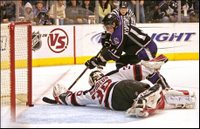 Los Angeles Kings' Anze Kopitar gets the puck past New Jersey Devils goalie Martin Brodeur to score the first goal of an overtime shootout during an NHL hockey game in Los Angeles Monday, Nov. 27, 2006. Kings won 3-2. (AP Photo/Branimir Kvartuc)