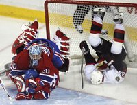 Montreal goaltender David Aebischer collides with teammate Mike Johnson as Ottawa's Patrick Eaves takes a tumble into the net. The Canadiens straightened out well enough to beat the Senators 4-2