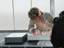 Actually, he's just poring over photo negatives...but doesn't it look like someone working in a lab, still? haha
