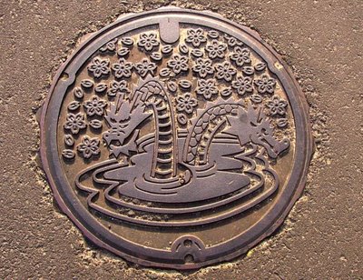 Drain. Kisuki Town, Shimane. Home of the Orochi legend, images of the 8-headed serpent are everywhere