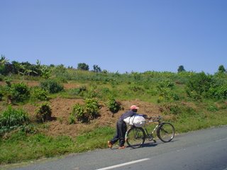 man going uphill on a bicycle