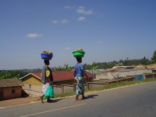 two women balancing lots of things on their heads