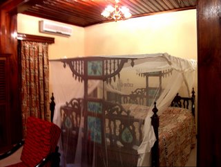 huge bed in a fancy Zanzibari bedroom