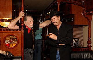 Kinky and Willie Nelson discuss renewable energy on Willie's biodiesel-powered bus. Photo by Brian Kanof.