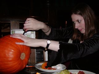 Nat carving a face into the pumpkin