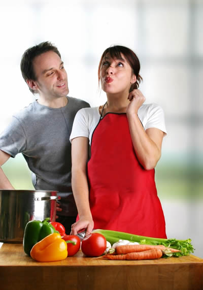 couple cooking Manola's paella