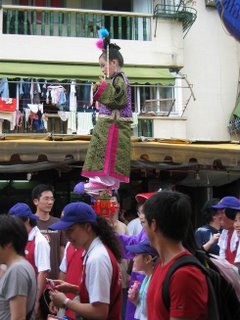 Child Floats Above the Crowd at the Cheung Chau Bun Festival