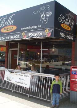 Tristan in front of Bella Pizza