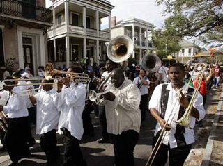 A band leads people down Esplanade Street during a second-line parade in New Orleans, Saturday.