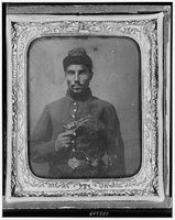 Seated black soldier with pistol and jacket, Library of Congress, Prints & Photographs Division, REPRODUCTION NUMBER: LC-USZ62-132209