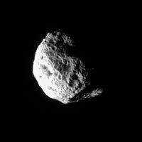 The tumbling and irregularly shaped moon Hyperion rotates away from the Cassini spacecraft.
