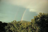 A primary and secondary rainbow - note reversal of spectrum Reversal caused by second bow being produced by 2 internal reflections, Image ID: wea00141, Historic NWS Collection, Location: View NE from Asheville, North Carolina, Photo Date: September 1975, Photographer: Grant W. Goodge.