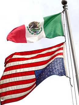 The Mexican Flag is displayed above the American flag. The American Flag is displayed upside down, a sign of distress.