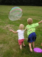 Kids Chasing a Big Bubble
