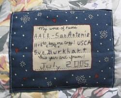 Photograph: Inscription by Sue Burkhart on one of the quilts.