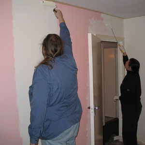 Our pink bedroom being painted cream.