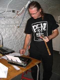 Joe typing with hammer
