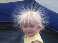 Kid with hair standing on ends caused by static electricity