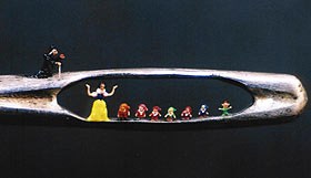 Snow White and the 7 dwarfs in the eye of a needle.