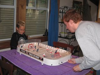 trey and alex playing table hockey