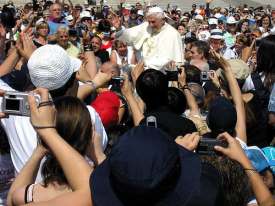 Egged on by Pope Benedict, the crowd prepare to burn their evil 21st Century cameras
