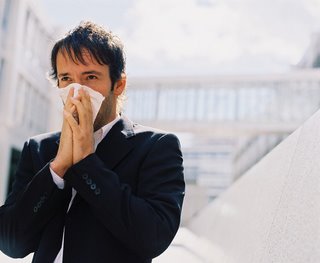 Corbis.com: Businessman blowing his nose