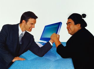 Corbis: Businessman Measures Itself in Arm Wrestling with a Japanese Sumo Wrestler