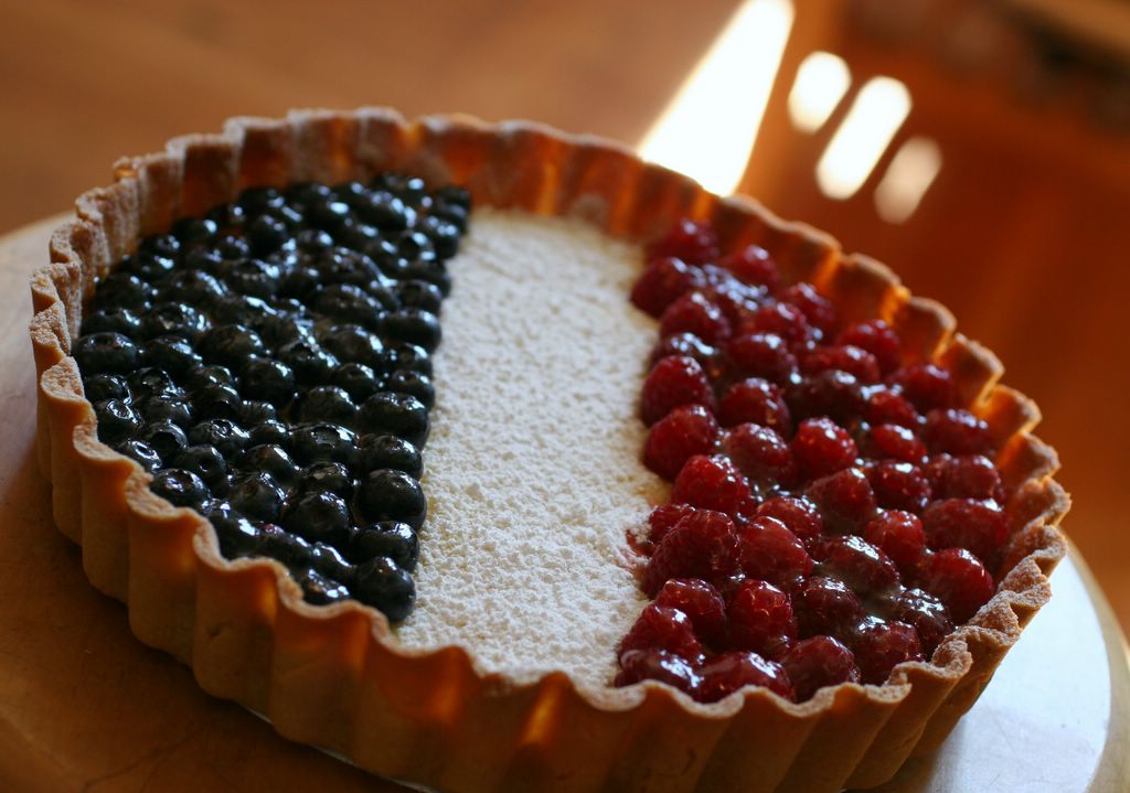 photograph picture tarte au citron lemon tart from a recipe by pierre herme in the cooks book with the addition of fruit blueberries and raspberries to make it look by the french flag