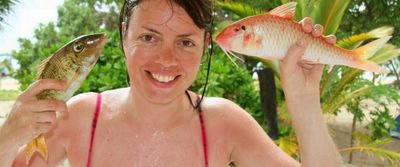 photograph picture of sam breach on the island of Kuata in Fiji with two freshly caught fish