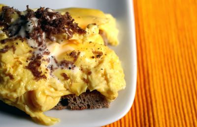 photograph picture poached scrambled eggs made by the method described by chef daniel patterson in the new york times served with creme fraiche and white truffle