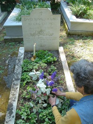 lady holmes arranging flowers at sir ronald's grave on 25th anniversary of his death in corfu